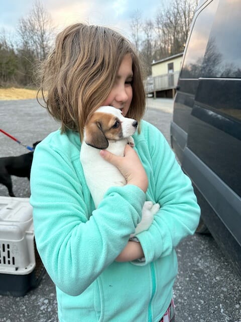 Little girl holding her new puppy at the Sullivan County Animal Shelter